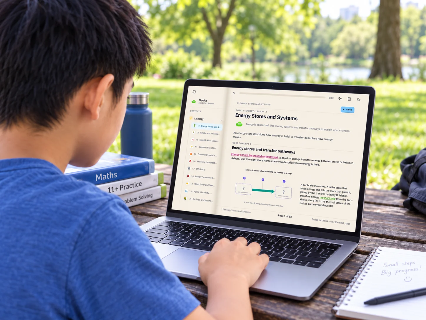 A boy at a picnic table in a park, working through the Ilmino textbook on a laptop